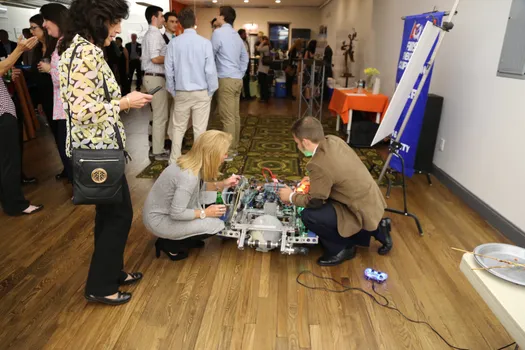A Team 5016 member explains one of the team’s robots, "Sherman", during the team's fundraiser event at LaunchPad of Huntington. Thank you to LaunchPad of Huntington for supporting us and allowing us to use their venue and to all of the sponsors for supporting Team 5016 so that we can continue to inspire the next generation of problem solvers.