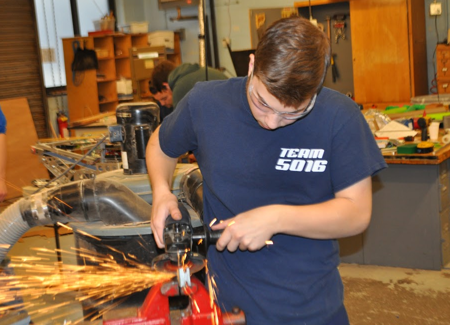 Student using metal grinder