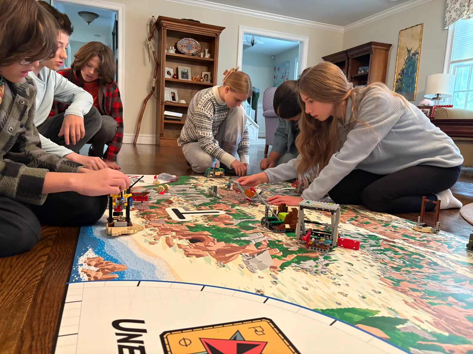 Students leaning in from every side of the field to place and test models